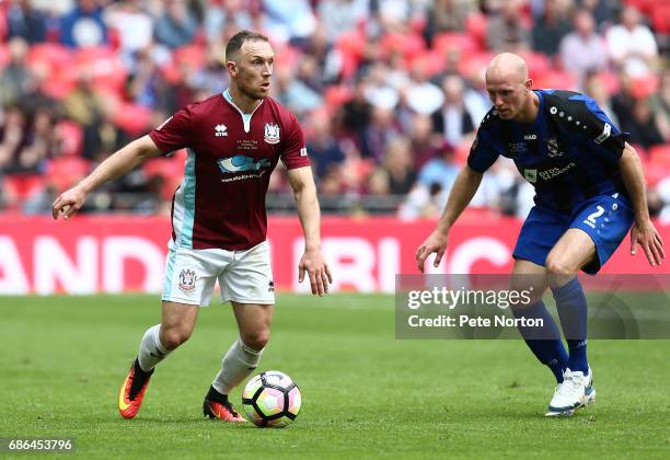 David Foley of South Shields looks to play the ball watched by Tim Lowe of Cleethorpes Town during The Buildbase FA Vase Final between South Shields...