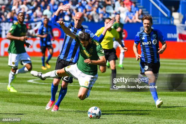 Portland Timbers midfielder Diego Valeri falling on the field after a collision with Montreal Impact defender Laurent Ciman during the Portland...