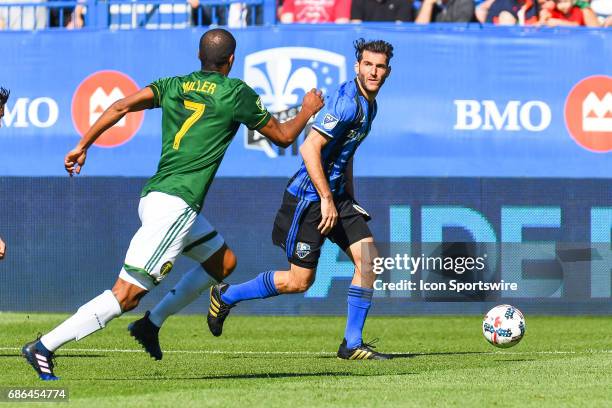 Montreal Impact midfielder Ignacio Piatti running on the field in control of the ball looking at Portland Timbers defender Roy Miller going to stop...