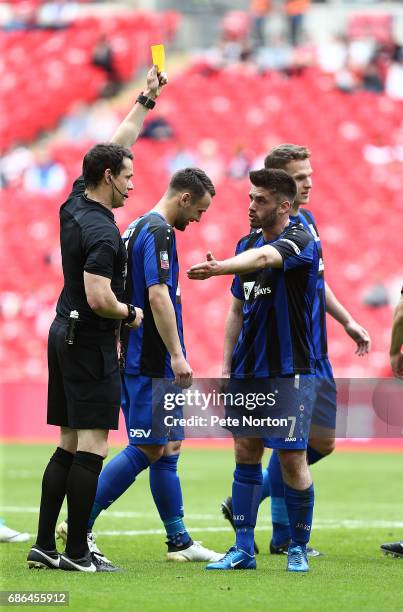 Referee Darren England shows a yellow card to Liam Davis of Cleethorpes Town during The Buildbase FA Vase Final between South Shields and Cleethorpes...