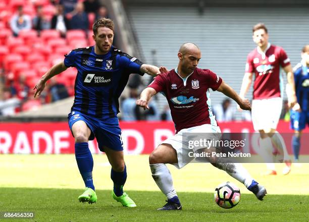 Wayne Phillips of South Shields plays the ball under pressure from Jack Richardson of Cleethorpes Town during The Buildbase FA Vase Final between...