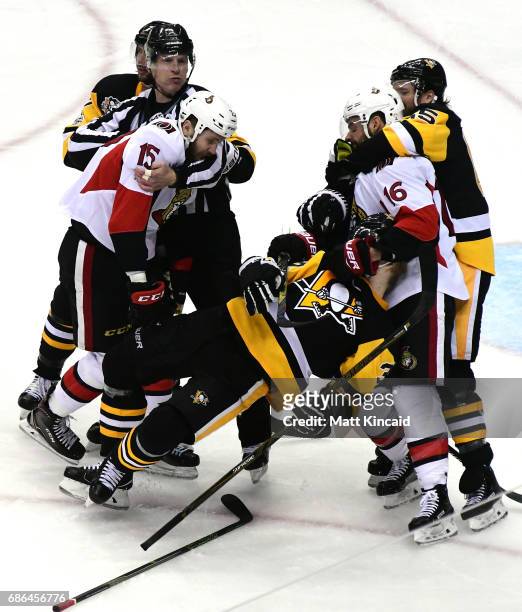 Zack Smith and Clarke MacArthur of the Ottawa Senators fight with Olli Maatta of the Pittsburgh Penguins during the third period in Game Five of the...