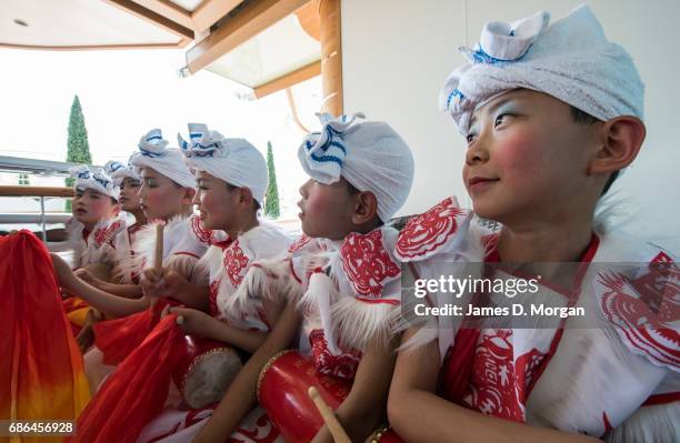 Boys from the Ansai waist drum troupe from Yan'an city, Shaanxi province, China aboard Princess Cruises' newest ship "Majestic Princess" sailing out...