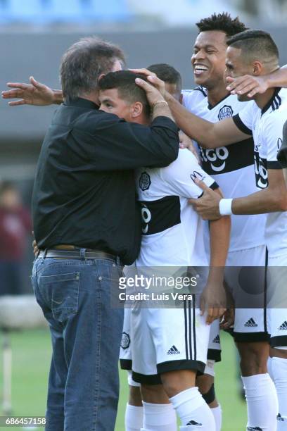 Richard Sanchez of Olimpia celebrates with his coach Ever Almeida and teammates Hernan Pellerano and Edcarlos Conceicao after scoring the first goal...