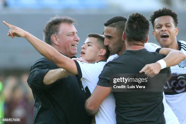 Richard Sanchez of Olimpia celebrates with his coach Ever Almeida and teammates Hernan Pellerano and Edcarlos Conceicao after scoring the first goal...