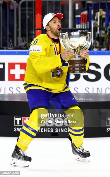 Joel Lundqvist of Sweden lifts the trophy after the 2017 IIHF Ice Hockey World Championship Gold Medal game Canada and Sweden at Lanxess Arena on May...