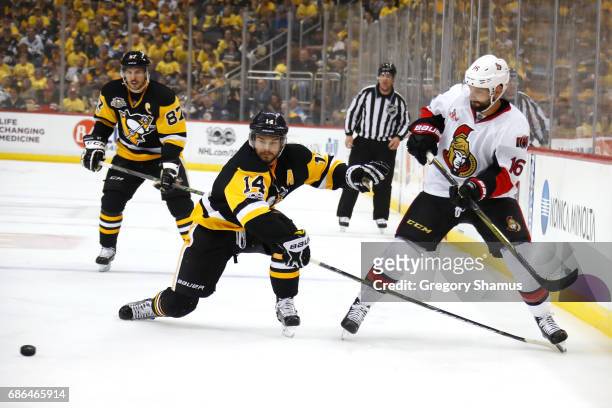 Chris Kunitz of the Pittsburgh Penguins looks for the puck against Clarke MacArthur of the Ottawa Senators in Game Five of the Eastern Conference...