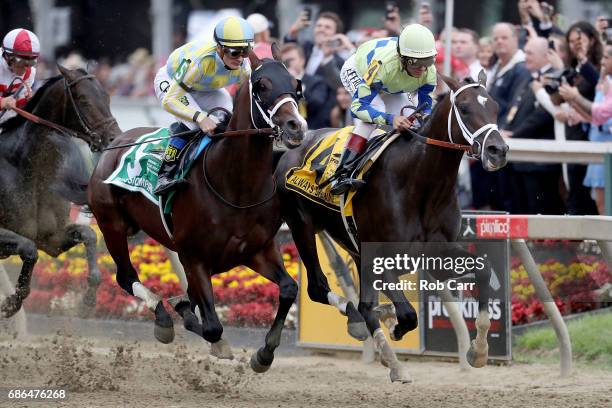 Classic Empire with jockey Julien Leparoux aboard and Always Dreaming with John Velazquez up head into the first turn during the 142nd Preakness...