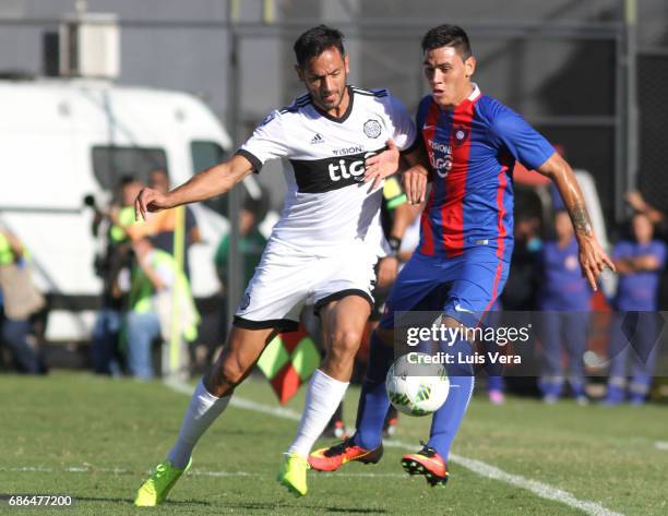 Roque Santa Cruz of Olimpia fights for the ball with William Candia of Cerro Porteño during a match between Olimpia and Cerro Porteño as part of the...