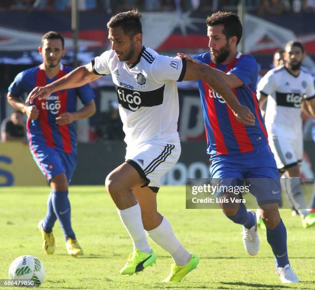 Roque Santa Cruz of Olimpia fights for the ball with Mauricio Victorino during a match between Olimpia and Cerro Porteño as part of the 17th round of...