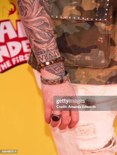 Singer Adam Lambert, jewelry detail, arrives at the premiere of 20th Century Fox's "Captain Underpants: The First Epic Movie" at the Regency Village...