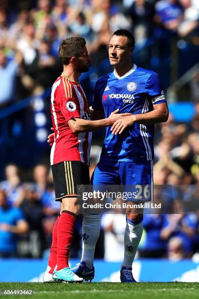 John Terry of Chelsea is embraced by Fabio Borini of Sunderland as he leaves the field after being substituted during the Premier League match...