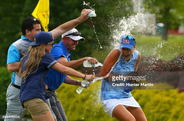 Lexi Thompson gets sprayed with water on the 18th green after winning the Kingsmill Championship presented by JTBC on the River Course at Kingsmill...