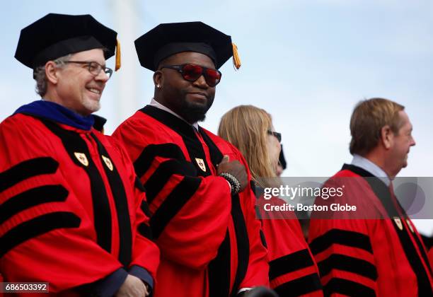 Former Boston Red Sox player David Ortiz gestures to graduates as he took the stage during Boston University Commencement on Nickerson Field on...