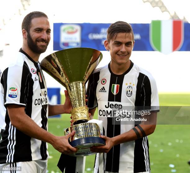 Gonzalo Higiuain and Paulo Dybala of Juventus pose the 'Scudetto' trophy to celebrate the win of the Italian Serie A 2016/2017 at the end of the...