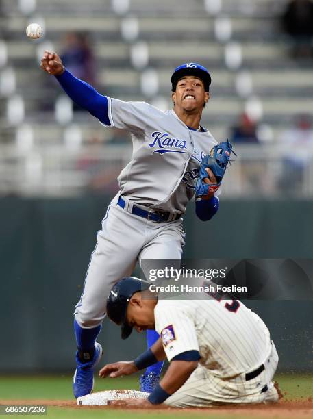 Eduardo Escobar of the Minnesota Twins is out at second base as Raul Mondesi of the Kansas City Royals turns a double play during the seventh inning...