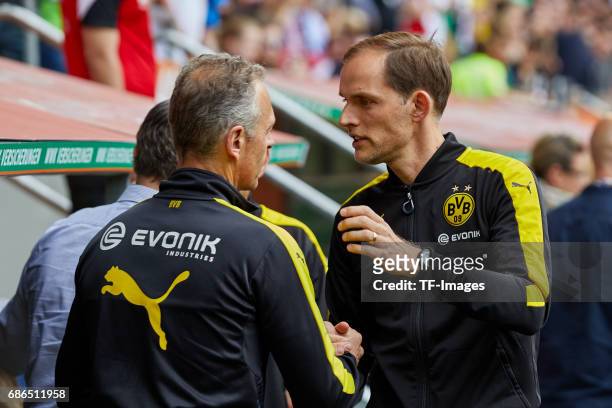 Rainer Schrey of Dortmund shakes hands with Head coach Thomas Tuchel of Dortmund during the Bundesliga match between FC Augsburg and Borussia...