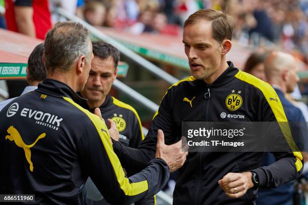 Rainer Schrey of Dortmund shakes hands with Head coach Thomas Tuchel of Dortmund during the Bundesliga match between FC Augsburg and Borussia...