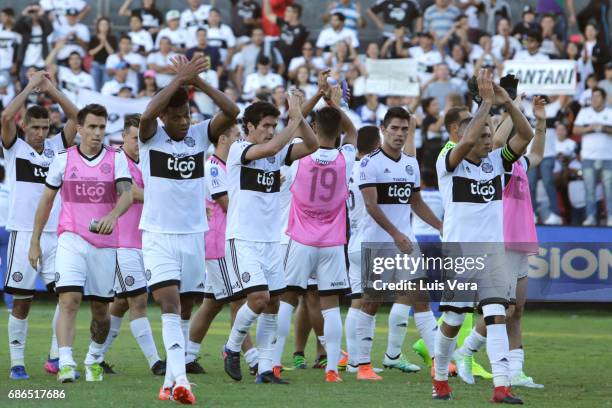 Edcarlos Conceicao of Olimpia celebrates with temamtes Richard Ortiz and Pablo Mouche after winning a match between Olimpia and Cerro Porteño as part...