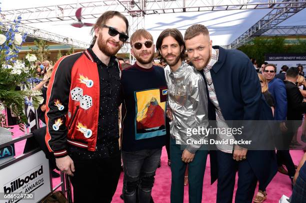 Musicians Daniel Platzman, Ben McKee, Wayne Sermon and Dan Reynolds of Imagine Dragons pose at SiriusXM's "Hits 1 in Hollywood" red carpet broadcast...