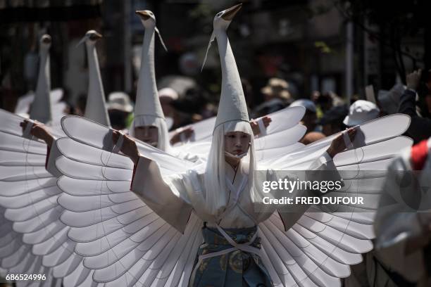 In this picture taken on May 19 heron-hooded dancers parade during the Sanja Matsuri festival in Tokyo. Over 1.5 million people flocked to Tokyo's...