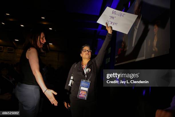 Woman came to the base of the stage shouting "validate the votes," in protest of Kimberly Ellis' loss of the California Democratic Party...