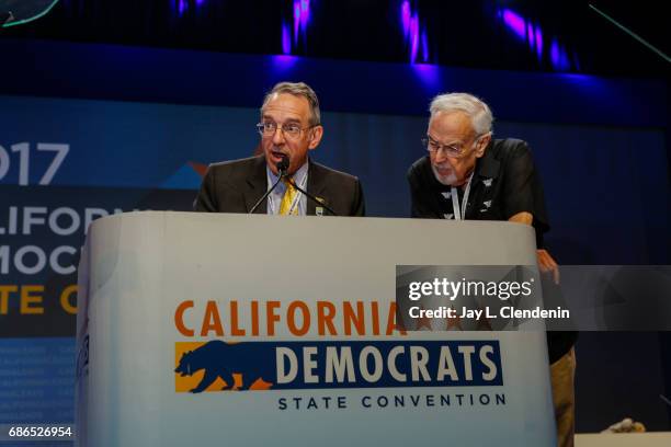 California Democratic Party special counsel, Coby King, left, with outgoing party Chairman John Burton, reads party bylaws to delegates after they...