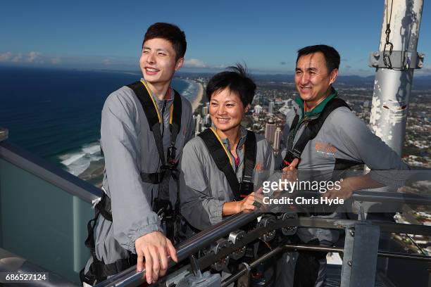 Badminton player Shi Yuqi poses with Ricky Yu and He Tian Tang of China on the Skydeck walk at the Skypoint Observation Deck on May 22, 2017 in Gold...