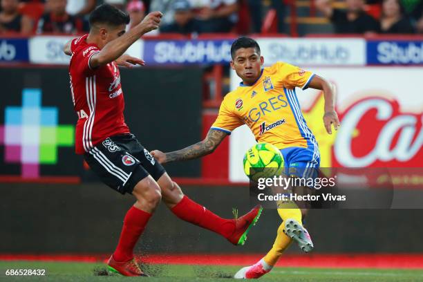 Javier Aquino of Tigres shoots to score the first goal of his team during the semi final second leg match between Tijuana and Tigres UANL as part of...