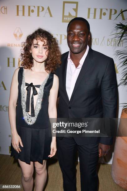 Actors Lily Collins and Adewale Akinnuoye-Agbaje attends the Hollywood Foreign Press Association's 2017 Cannes Film Festival Event in honour of the...
