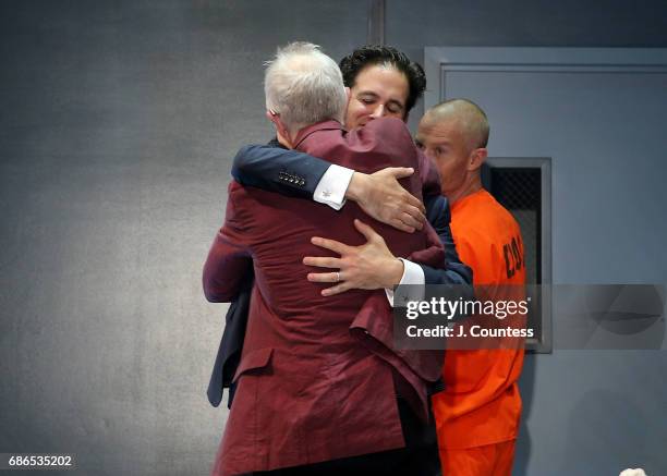 Playwright Robert Schenkkan hugs director Ari Edelson during curtain call on the opening night of "Building The Wall" at New World Stages on May 21,...