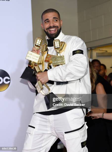 Rapper Drake poses in the press room with his awards for Top Artist, Top Male Artist, Top Billboard 200 Artist, Top Billboard 200 Album for 'Views,'...