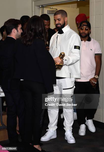 Rapper Drake poses in the press room with his awards for Top Artist, Top Male Artist, Top Billboard 200 Artist, Top Billboard 200 Album for 'Views,'...