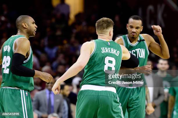 Avery Bradley celebrates with Jonas Jerebko of the Boston Celtics after their 111 to 108 win over the Cleveland Cavaliers during Game Three of the...