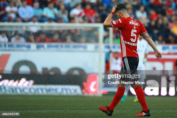 Guido Rodriguez of Tijuana leaves the field after receiving a red card during the semi finals second leg match between Tijuana and Tigres UANL as...