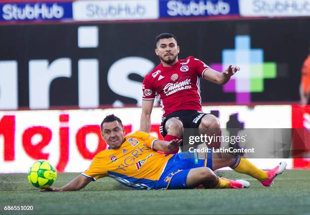 Alberto Acosta of Tigres and Henry Martin of Tijuana fight for the ball during the semi finals second leg match between Tijuana and Tigres UANL as...