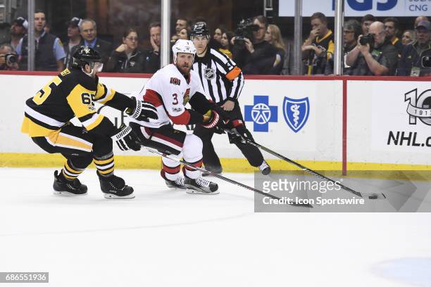 Ottawa Senators defenseman Marc Methot skates with the puck around Pittsburgh Penguins Defenseman Ron Hainsey during the first period in Game Five of...