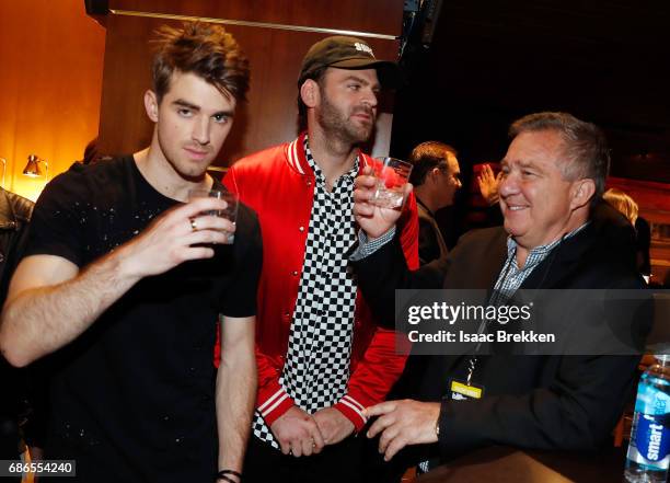 Andrew Taggart and Alex Paul of the Chainsmokers with Jaime Roberts visit the Virginia Black VIP lounge during the 2017 Billboard Music Awards at...