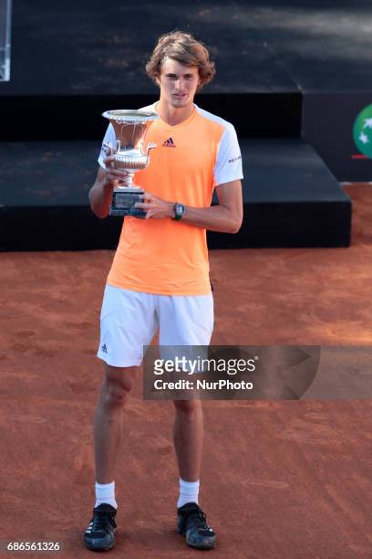 Alexander Zverev of Germany poses with the trophy after winning the ATP Singles Final match between Alexander Zverev of Germany and Novak Djokovic of...