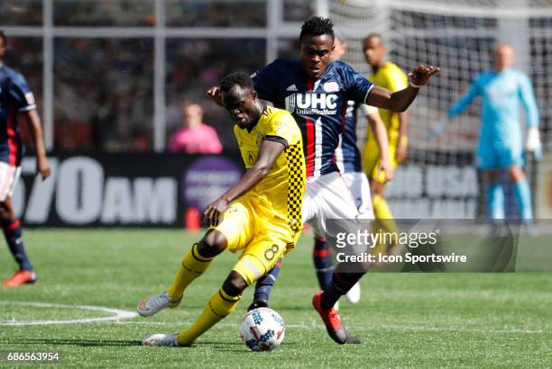 Columbus Crew midfielder Mohammed Abu slips in front of New England Revolution midfielder Gershon Koffie during a regular season MLS match between...
