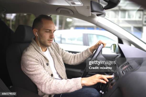 young man in car - motorheadphones stock pictures, royalty-free photos & images