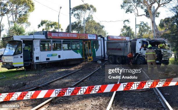 Australian security forces and policemen take security measures at the scene of a tram-truck collision in Parkville district of Melbourne, Australia...