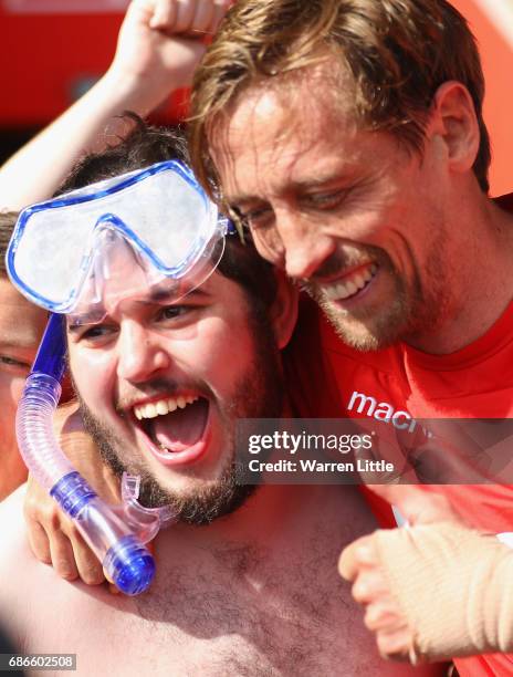 Peter Crouch of Stoke City hands over his shirt to the fan he chatted on Twitter pictured after the Premier League match between Southampton and...