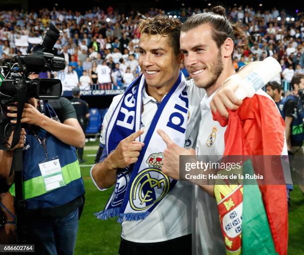 Cristiano Ronaldo of Real Madrid and Gareth Bale of Real Madrid celebrate after their team are crowned champions following the La Liga match between...