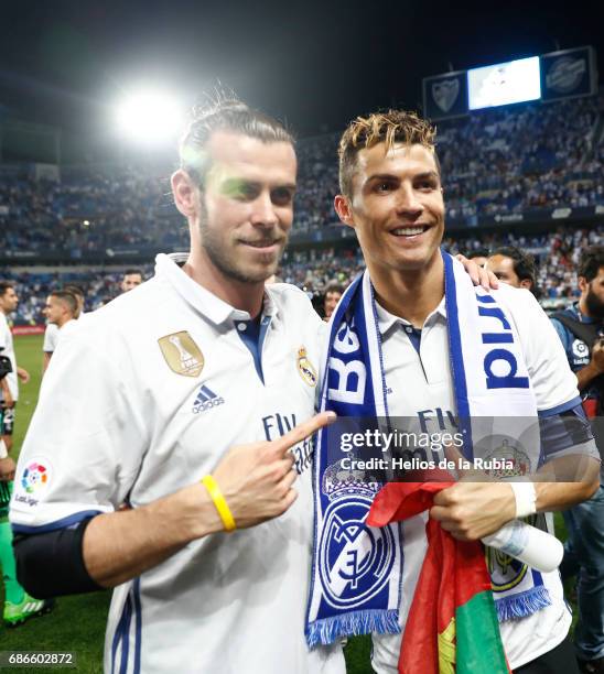 Cristiano Ronaldo of Real Madrid and Gareth Bale of Real Madrid celebrate after their team are crowned champions following the La Liga match between...