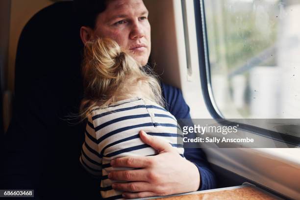 Father and daughter on a train
