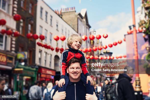 family walking through chinatown - london child foto e immagini stock