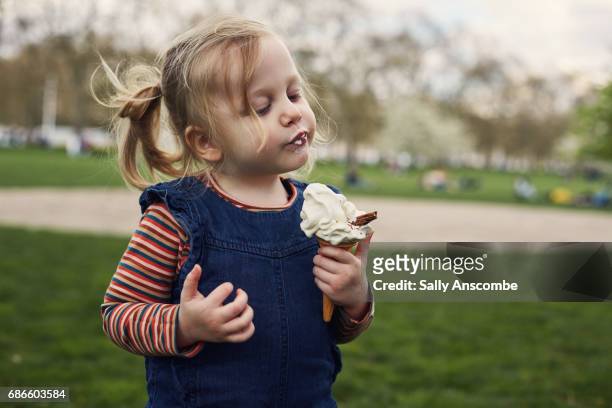 child enjoying eating an ice cream - indulgence stock pictures, royalty-free photos & images