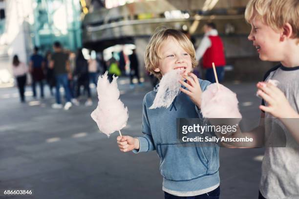 children eating candy floss - candy floss stock pictures, royalty-free photos & images