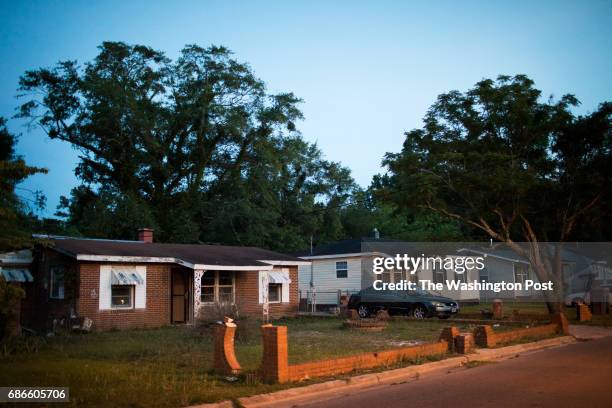 Damaged house from Hurricane Matthew is left abandoned next to a reconstructed house in the Sunset Heights neighborhood on May 19, 2017 in Lumberton,...